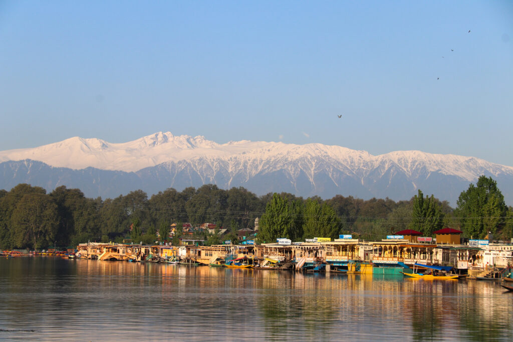 Srinagar, Kashmir, India: Landscape of houseboats on Dal Lake with snow mountain