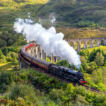 Jacobite steam train on Glenfinnan viaduct in Scotland, United Kingdom