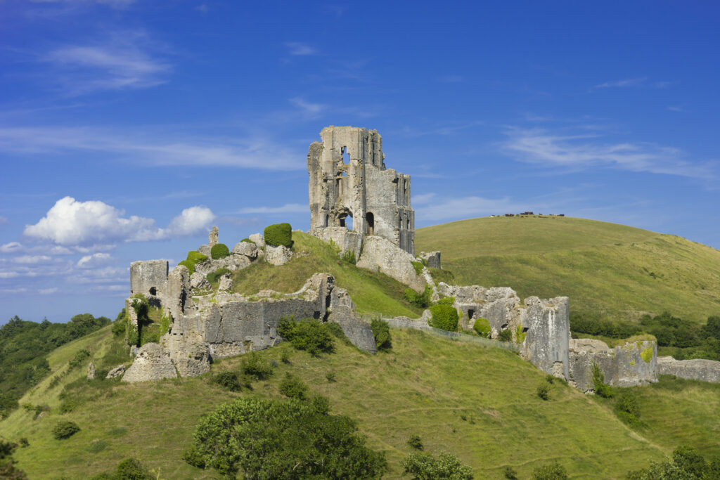 View of Corfe Castle in the Purbeck Hills of Dorset seen from West Hill