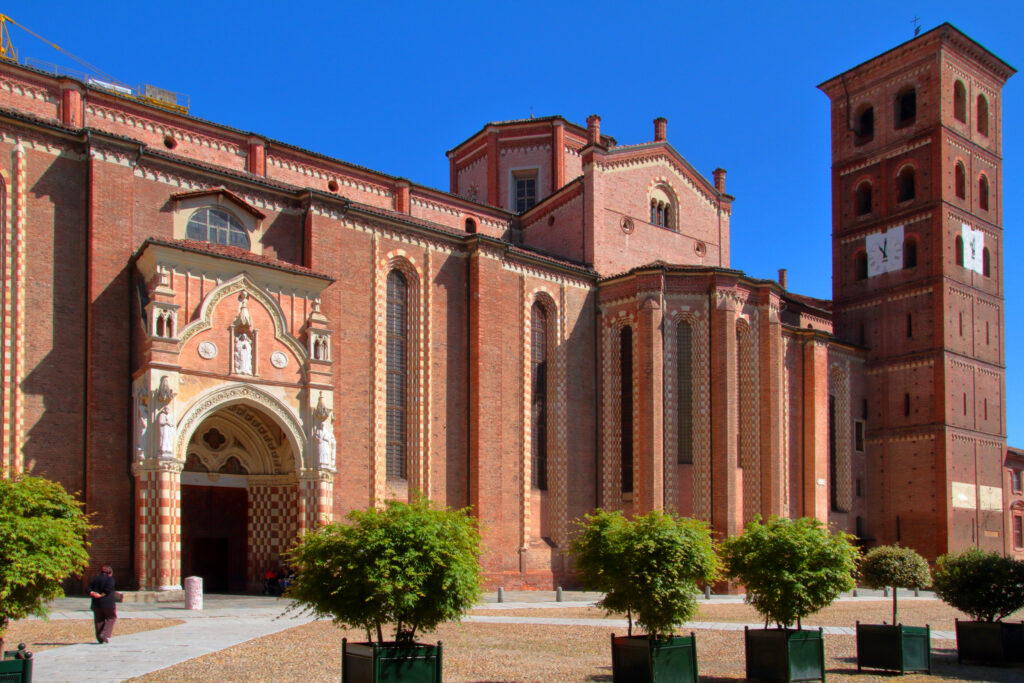 OLD CHURCH IN THE DOWNTOWN OF ASTI IN ITALY WITH RED BRICK WALL