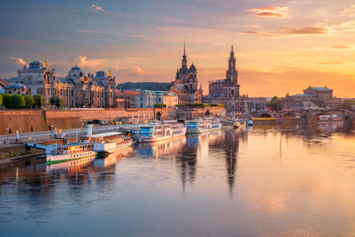 Cityscape image of Dresden, Germany with reflection of the city in the Elbe river, during sunset