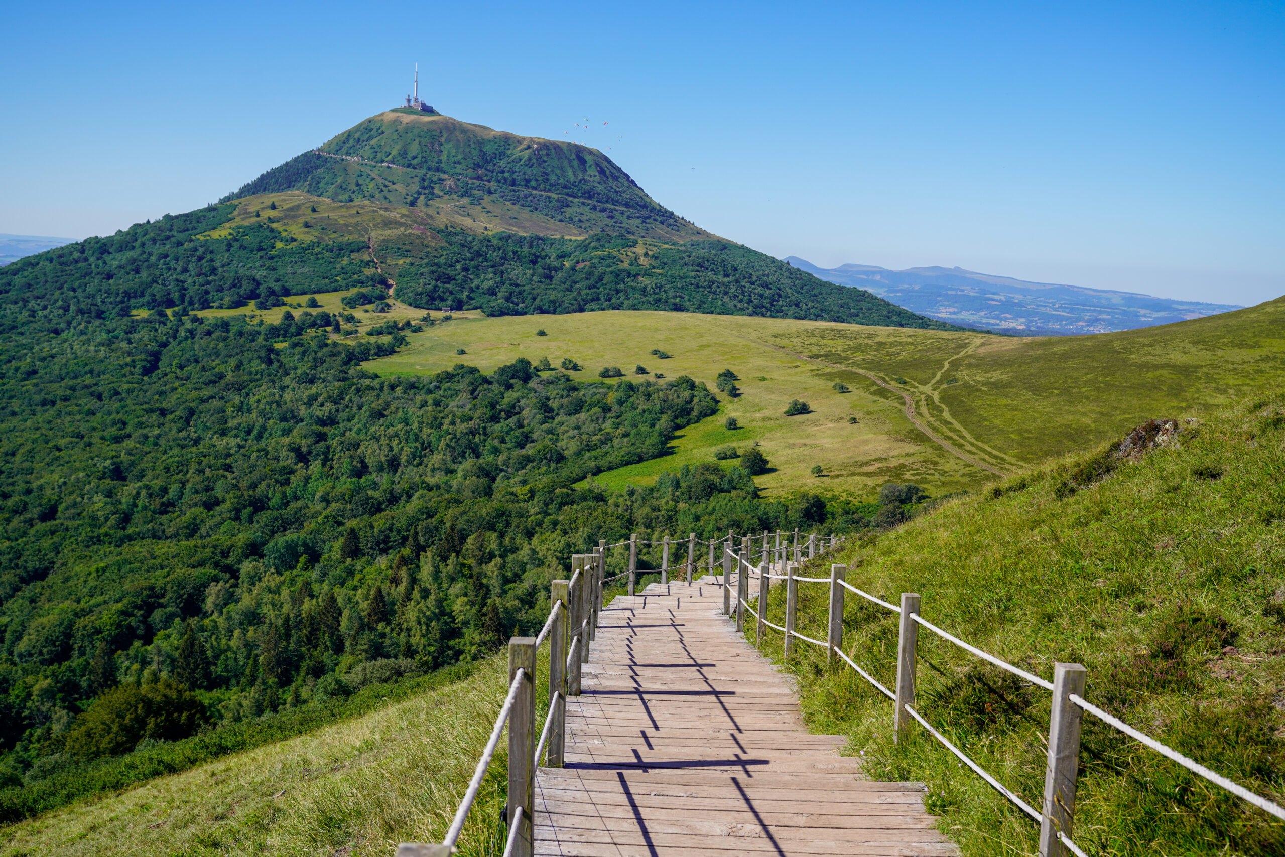 A wooden walking pathway in puy de dome french mountain volcano in summer day