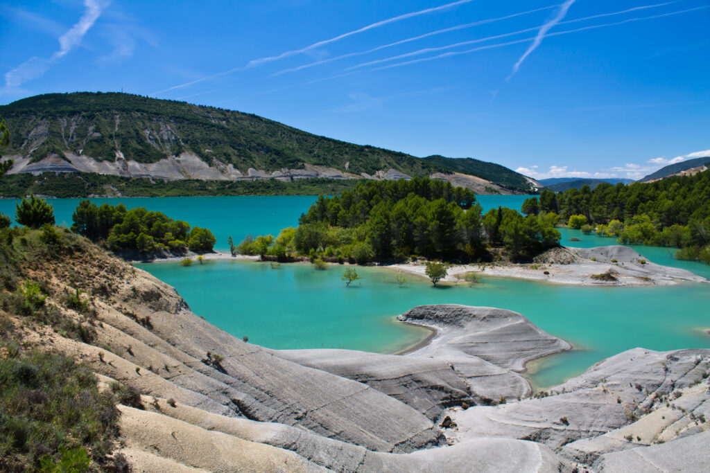 Colorful landscape with artificial turquoise lake and yellow trees, Pantano Yesa, Spain