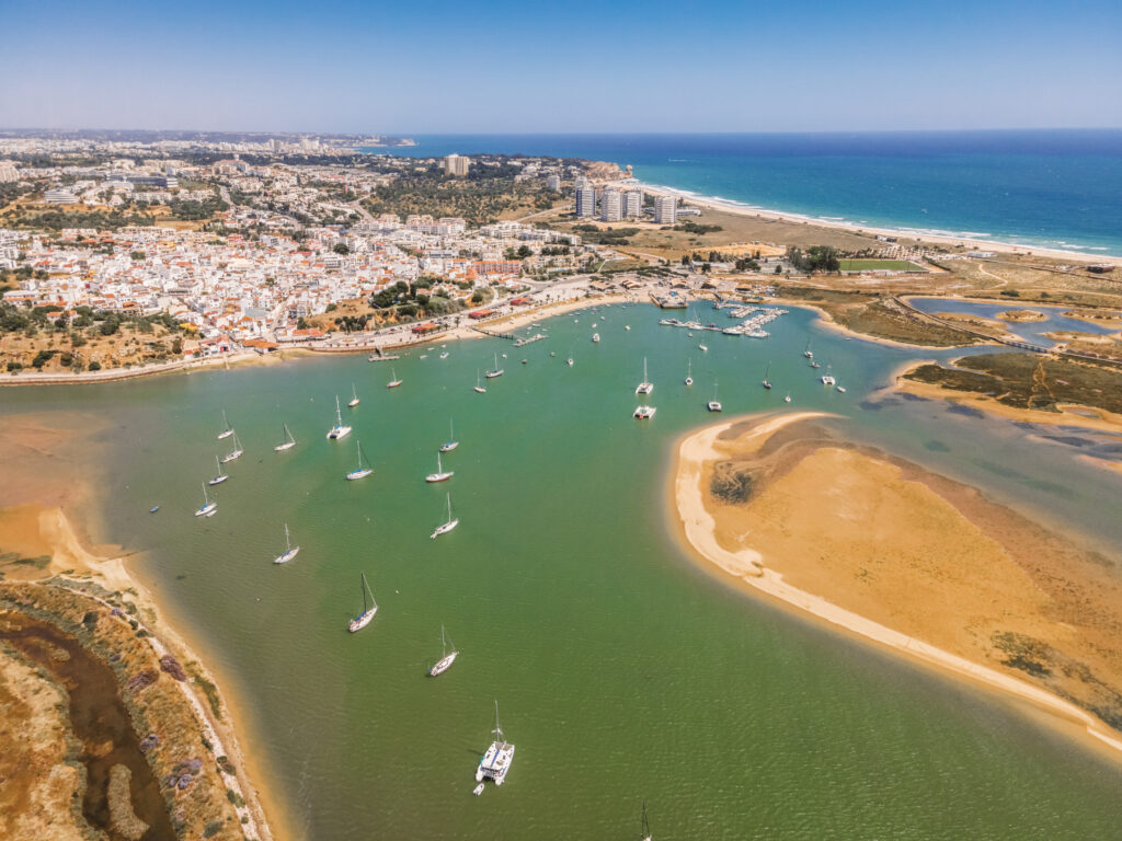 Aerial view of bay with yachts and city of Alvor, Algarve, Portugal