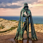 The King Arthur statue Gallos by Rubin Eynon stands on a rocky headland on the Atlantic coast of Cornwall