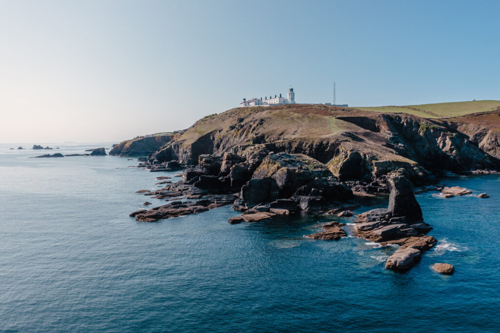 A view from the ocean of Trinity House heritage lighthouse on The Lizard Peninsula in Cornwall