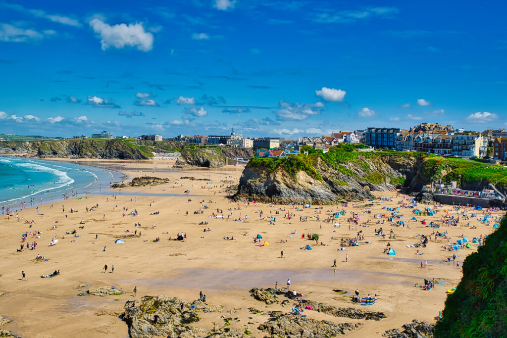 Sunny Beach Day with Cliffs and Crowds at Towan Beach, Newquay, UK