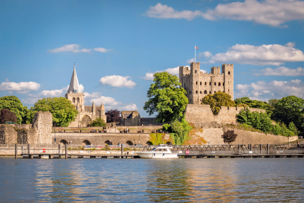 View of historical Rochester across river Medway in sunny afternoon