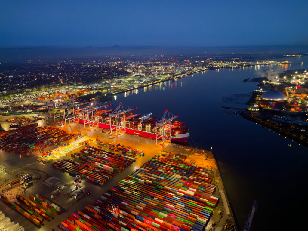 Illuminated Southampton UK container terminal with large container ship aerial