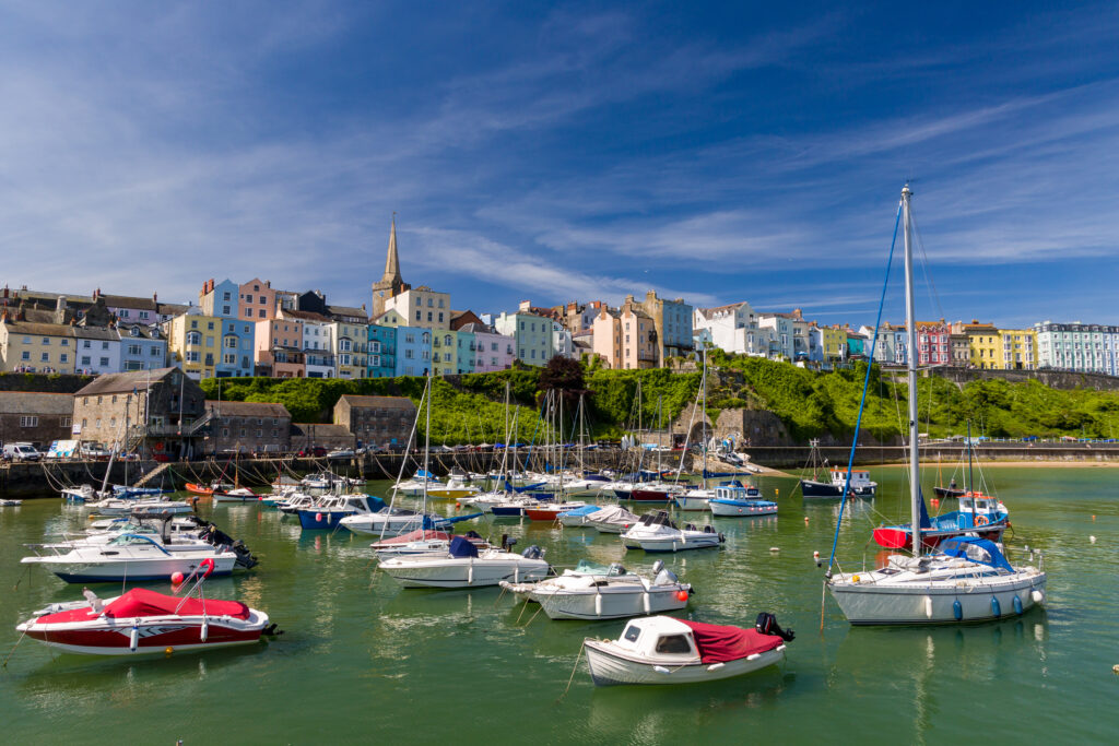 Colourful boats and buildings around the harbour of the Welsh seaside town of Tenby in Pembrokeshire