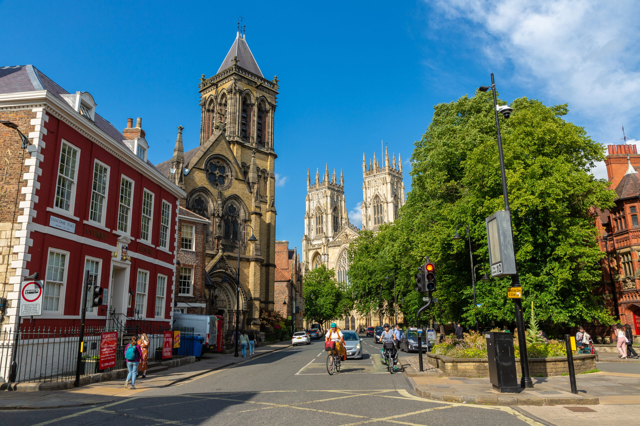 View of The York Oratory and iconic York Minster under blue sky in York, North Yorkshire, England, United Kingdom