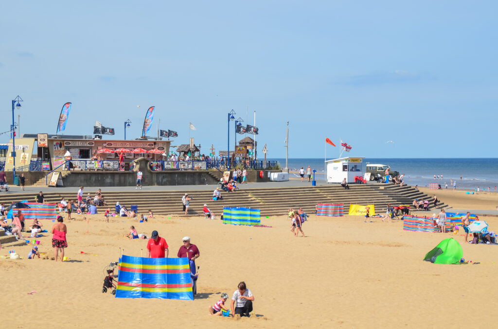 Busy summer seaside beach ay Mablethorpe, Lincolnshire, Uk with holiday makers enjoying sun