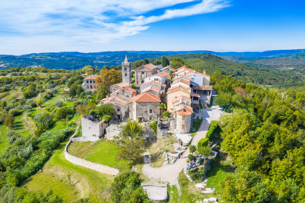 Beautiful old town of Hum on the hill, countryside landscape in Istria, Croatia, aerial view from drone