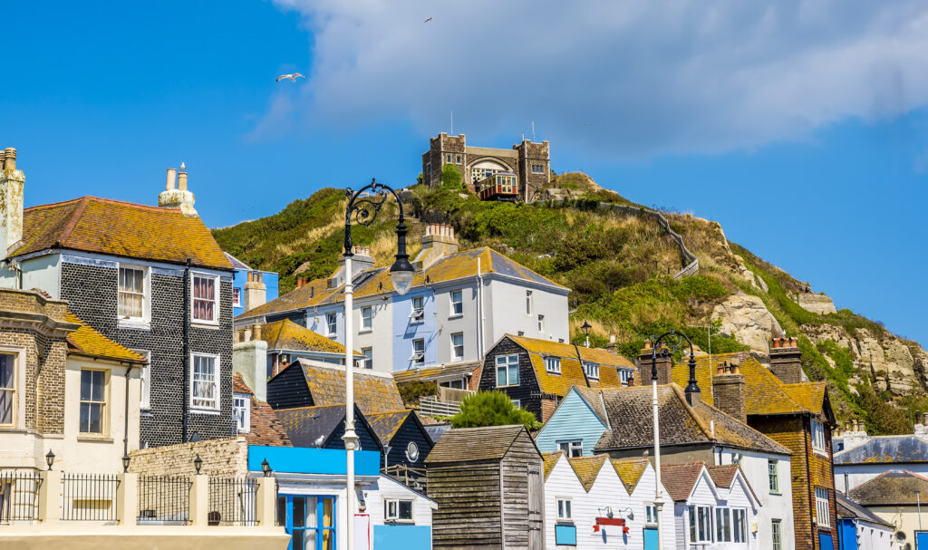 The unique and individual buildings of Hastings old town dominated by the east cliff and funicular railway in summer