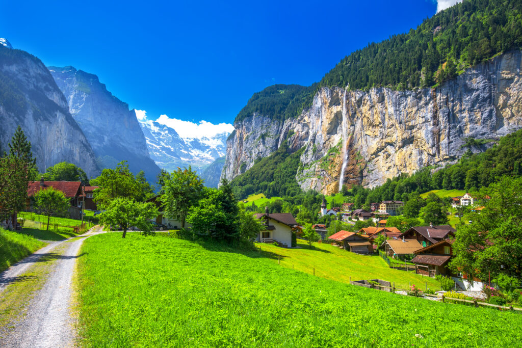 Famous Lauterbrunnen valley with gorgeous waterfall and Swiss Alps in the background