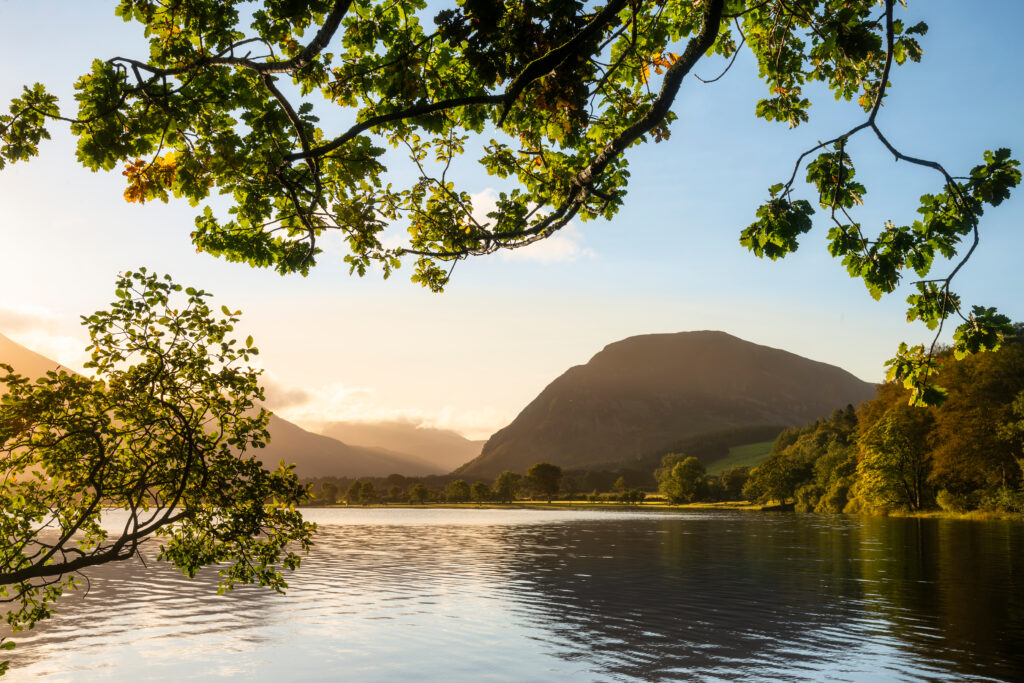 Lovely sunrise landscape image looking along Loweswater towards wonderful light on Grasmoor and Mellbreak mountains in Lake District