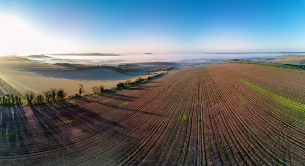 An aerial view on a misty autumn morning over Cranborne Chase AONB in Wiltshire, UK