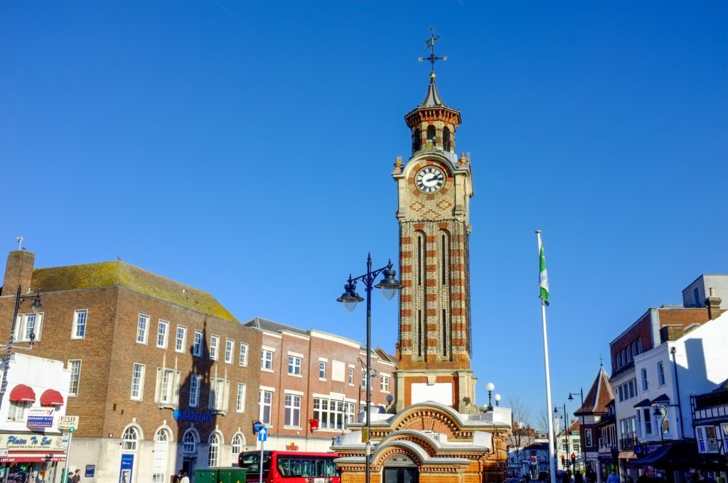 Clock tower against a blue sky in Epsopm town centre