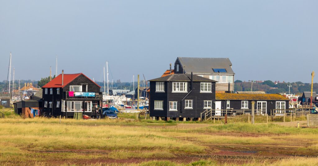 Black timber clad buildings near the Rive Blyth, Walberswick