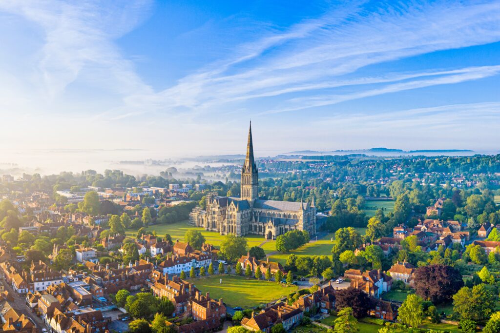Aerial view over Salisbury and Salisbury Cathedral on a misty summer morning, Salisbury, Wiltshire, England, United Kingdom, Europe