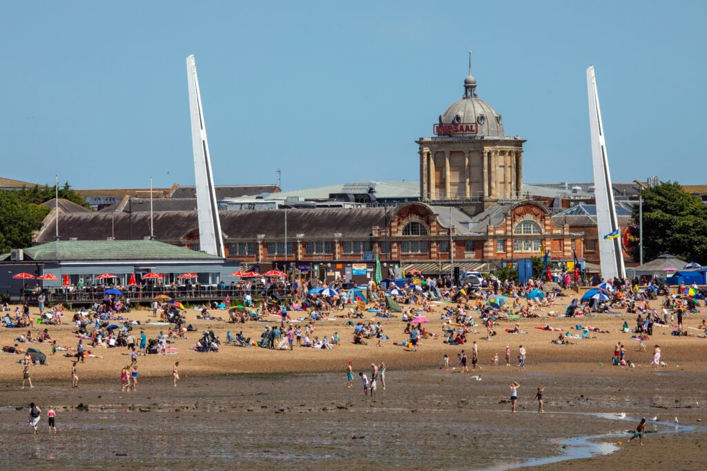 Essex, UK - July 28th 2024: View from Southend Pier of the beach and Kursaal in Southend-on-Sea, Essex