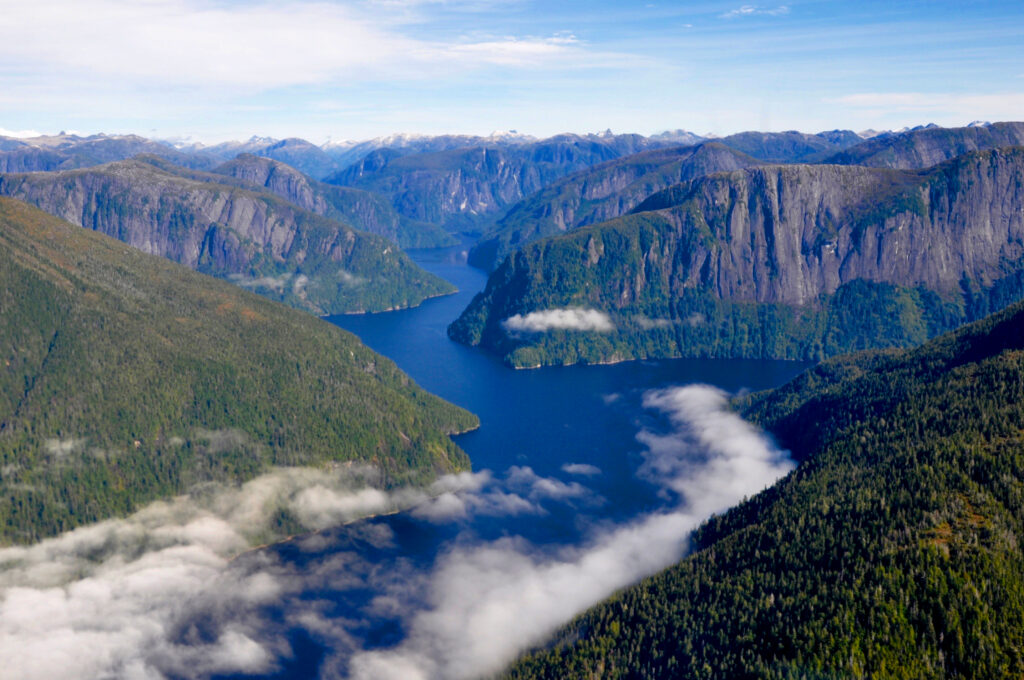 Misty Fjords National Monument aerial view in Tongass National Park with clouds rolling in the valley on a fall day in Alaska near Ketchikan