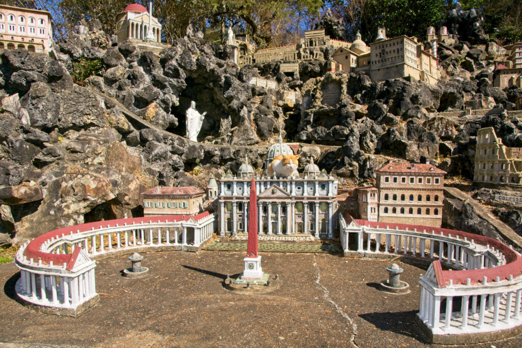 Cat on top of model of St. Peters Church of Rome in Ave Maria Grotto in Cullman Alabama