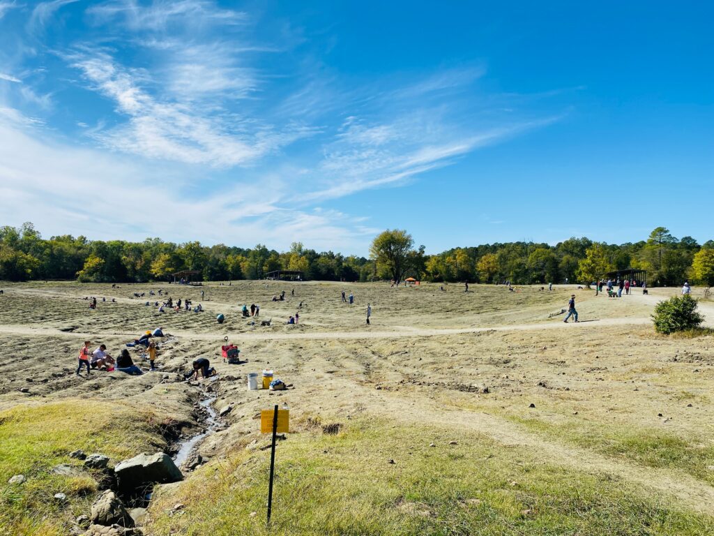 The field at the Crater of diamonds State Park with people digging for diamonds. Any gems including diamonds can be kept by the finder