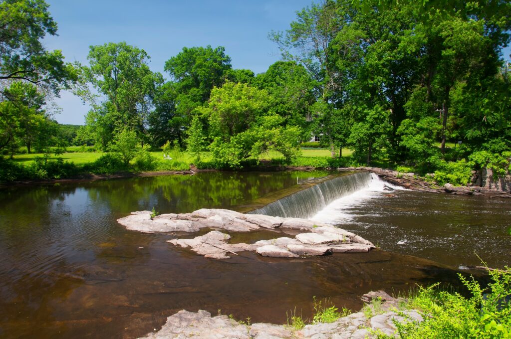 the shepaug river in roxbury connecticut on a sunny summer day in new england.