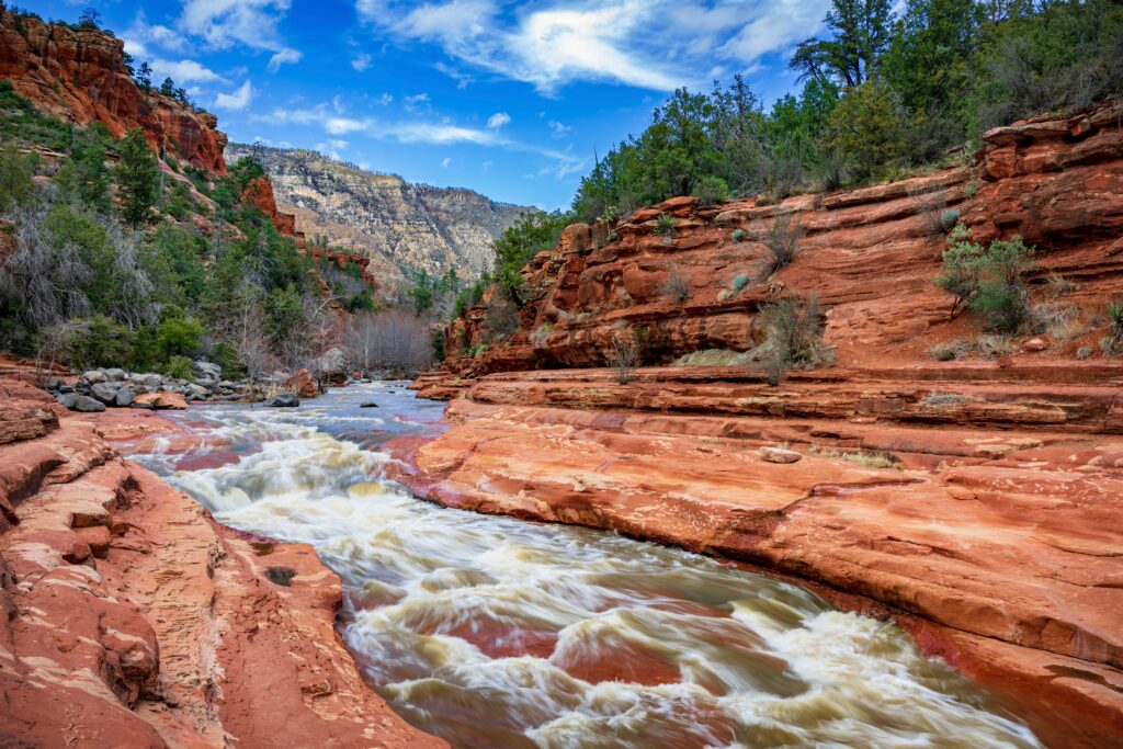 Oak Creek rushes through red sandstone at Slide Rock State Park near Sedona Arizona