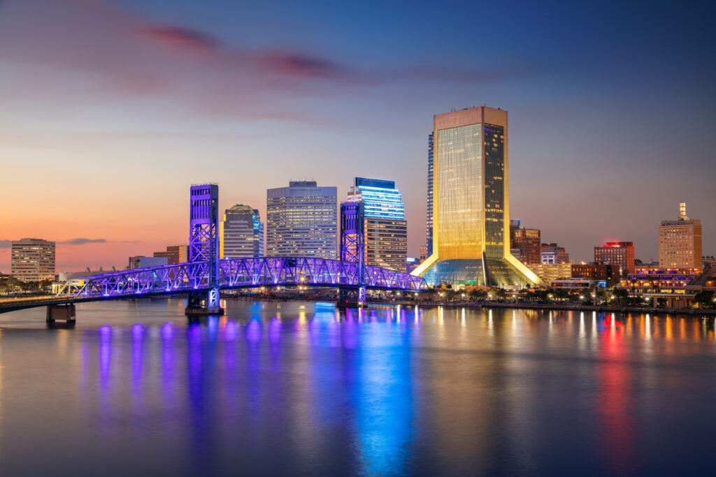 Jacksonville, Florida, USA. Cityscape image of Jacksonville, Florida with reflection of the city skyline in the water at beautiful sunset.