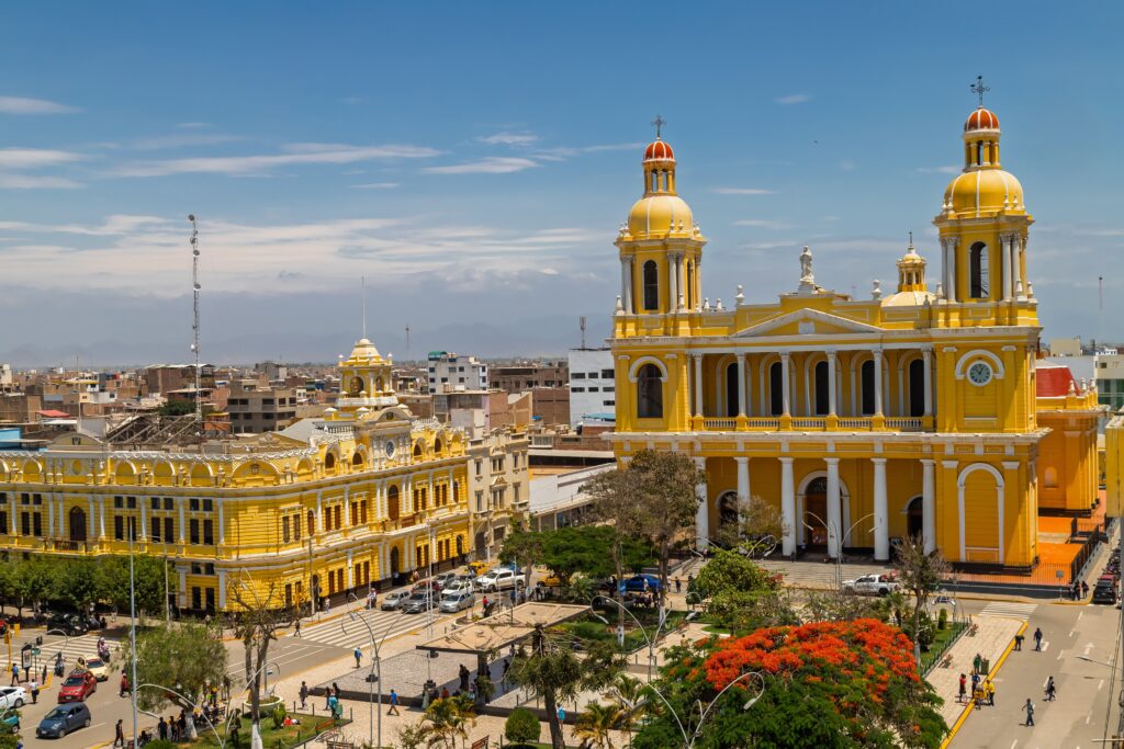 Chiclayo, Peru: General view of the city's main square, the municipal palace and the cathedral with the city and hills in the background