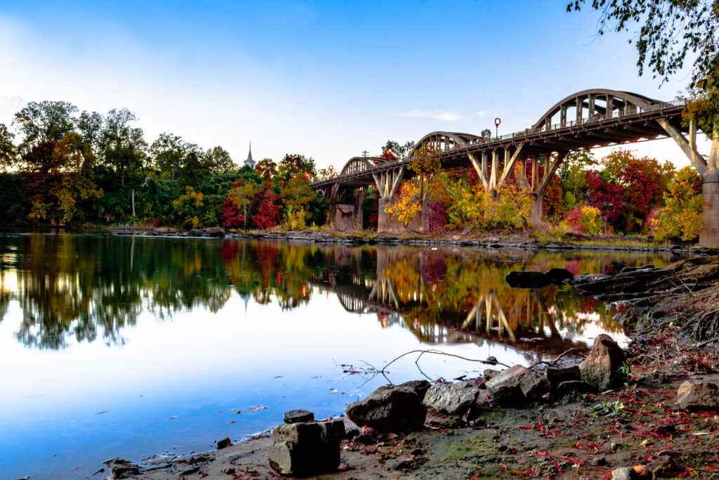Wetumpka, Alabama, USA: View of the Bibb Graves Bridge and fall folliage from the eastern shore of the Coosa River
