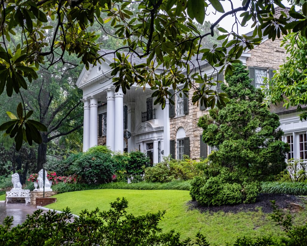 The front entrance to Elvis Presley's Family Home, Graceland. Taken on a rainy day from the side of the mansion looking through mature trees