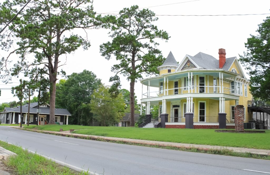 Opelousas, Louisiana United States: a historic home with a pine tree in the yard 