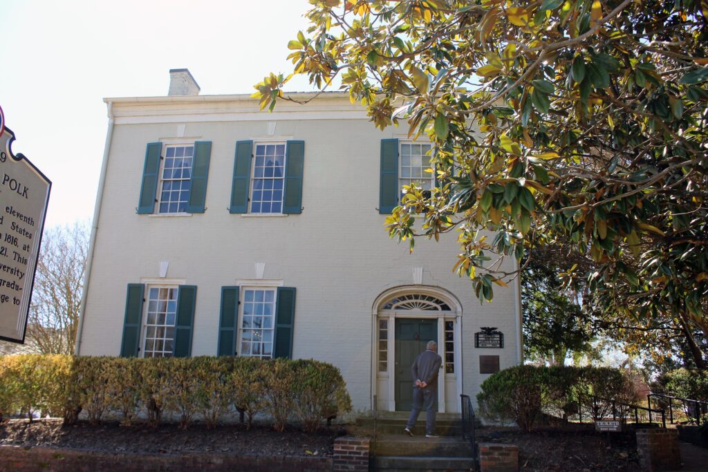 Columbia TN USA: Tourist reads sign at door of home of James K Polk, 11th President of the USA. Built in 1816, in the Federalist style, it was Polk’s modest home until 1824.
