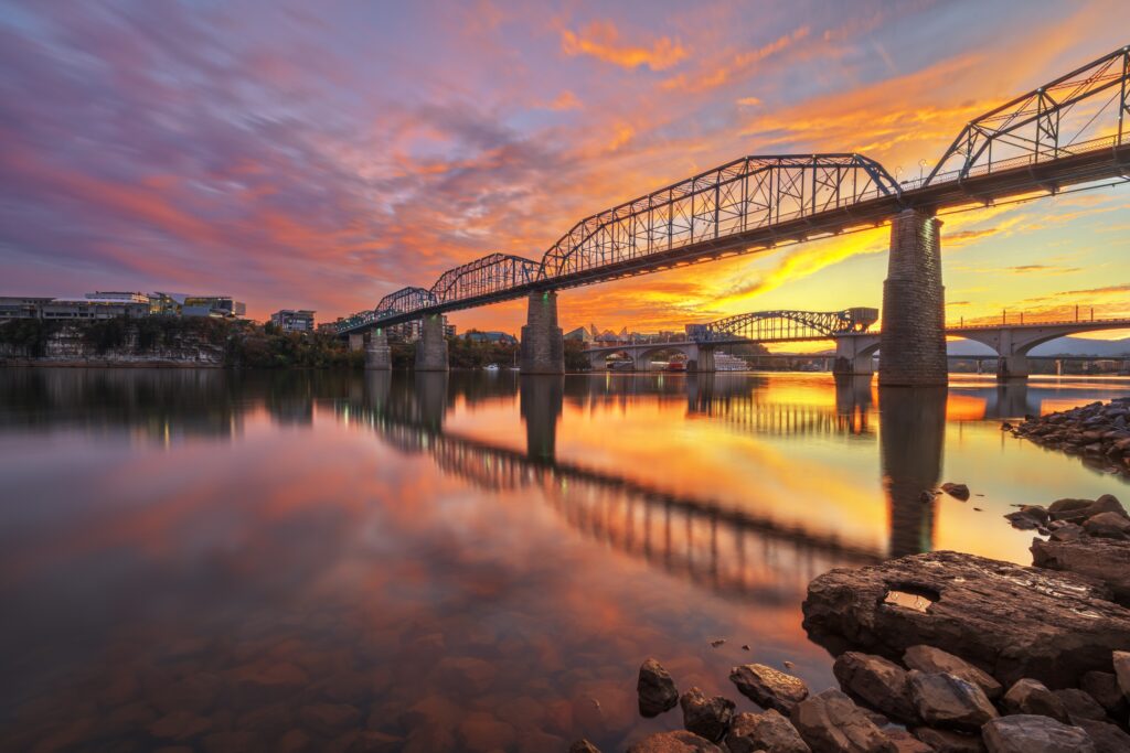 Chattanooga, Tennessee, USA on the Tennessee River with landmark bridges just after sunset.