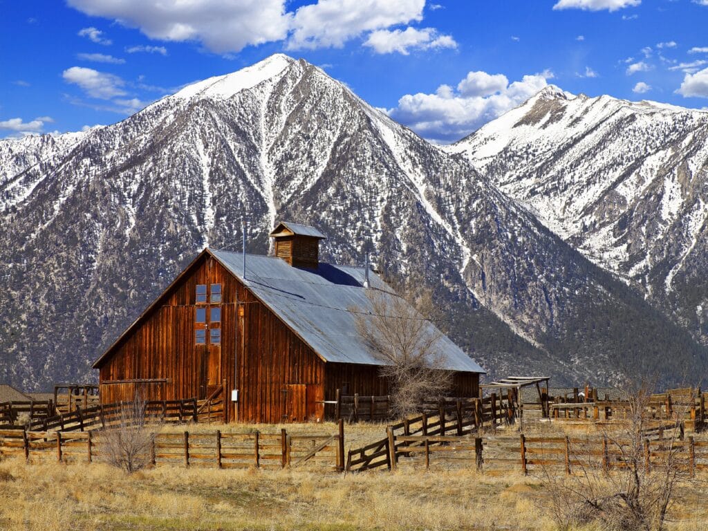 Snow capped mountains and an old barn in Carson valley, Nevada