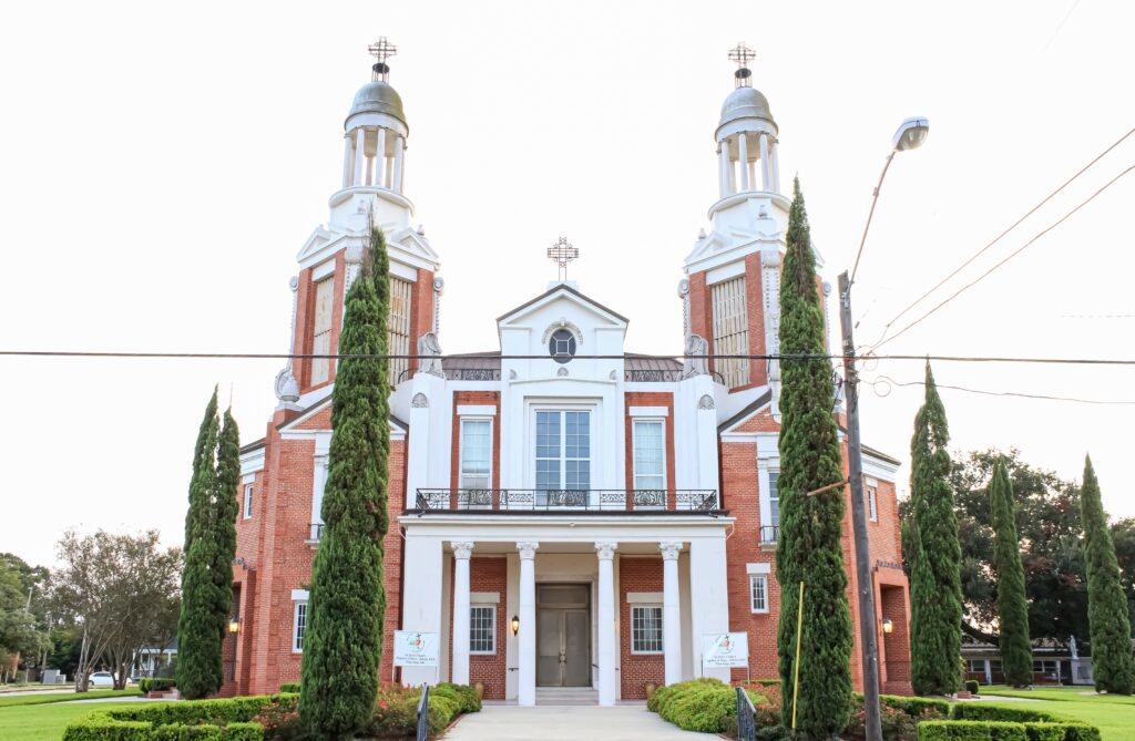 New Iberia, Louisiana United States: a historic church building with tall trees 