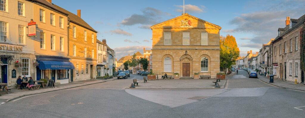 Woodstock, Oxfordshire, England, UK: Scenic panoramic view of the town hall and square of the small town of Woodtsock at dusk