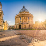 Radcliffe square with Science Library and sunset flare in Oxford, England