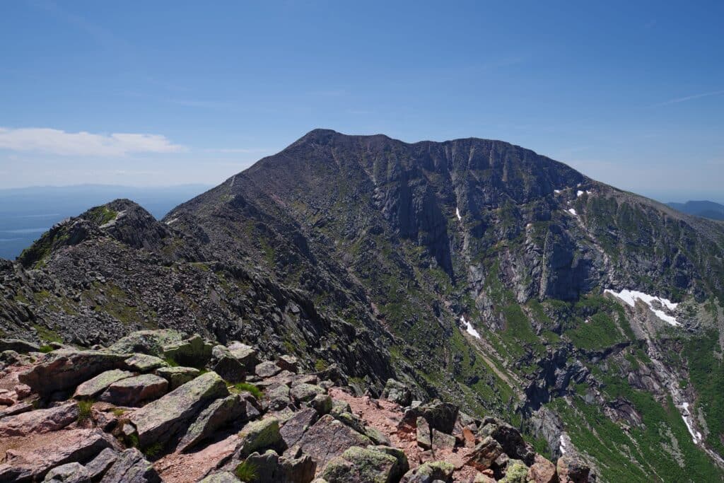 From the summit of Pamola Peak the majestic Mount Katahdin mountain range rises in the distance on a beautiful summer day
