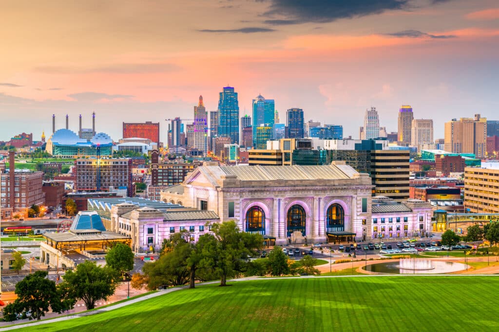 Kansas City, Missouri, USA downtown skyline with Union Station at dusk.