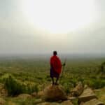 Maasai warrior standing with his spear overlooking his land in Kenya