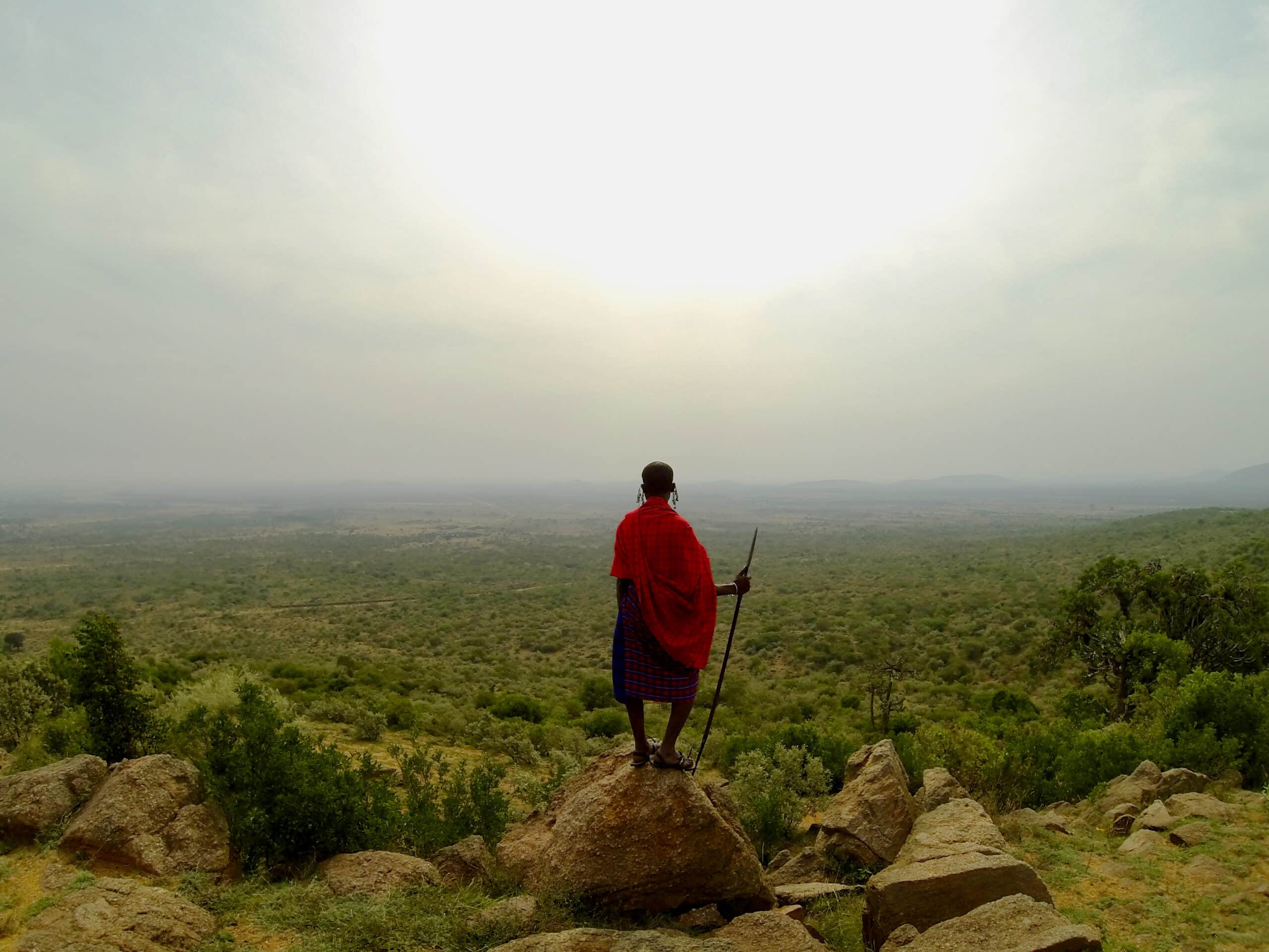 Maasai warrior standing with his spear overlooking his land in Kenya