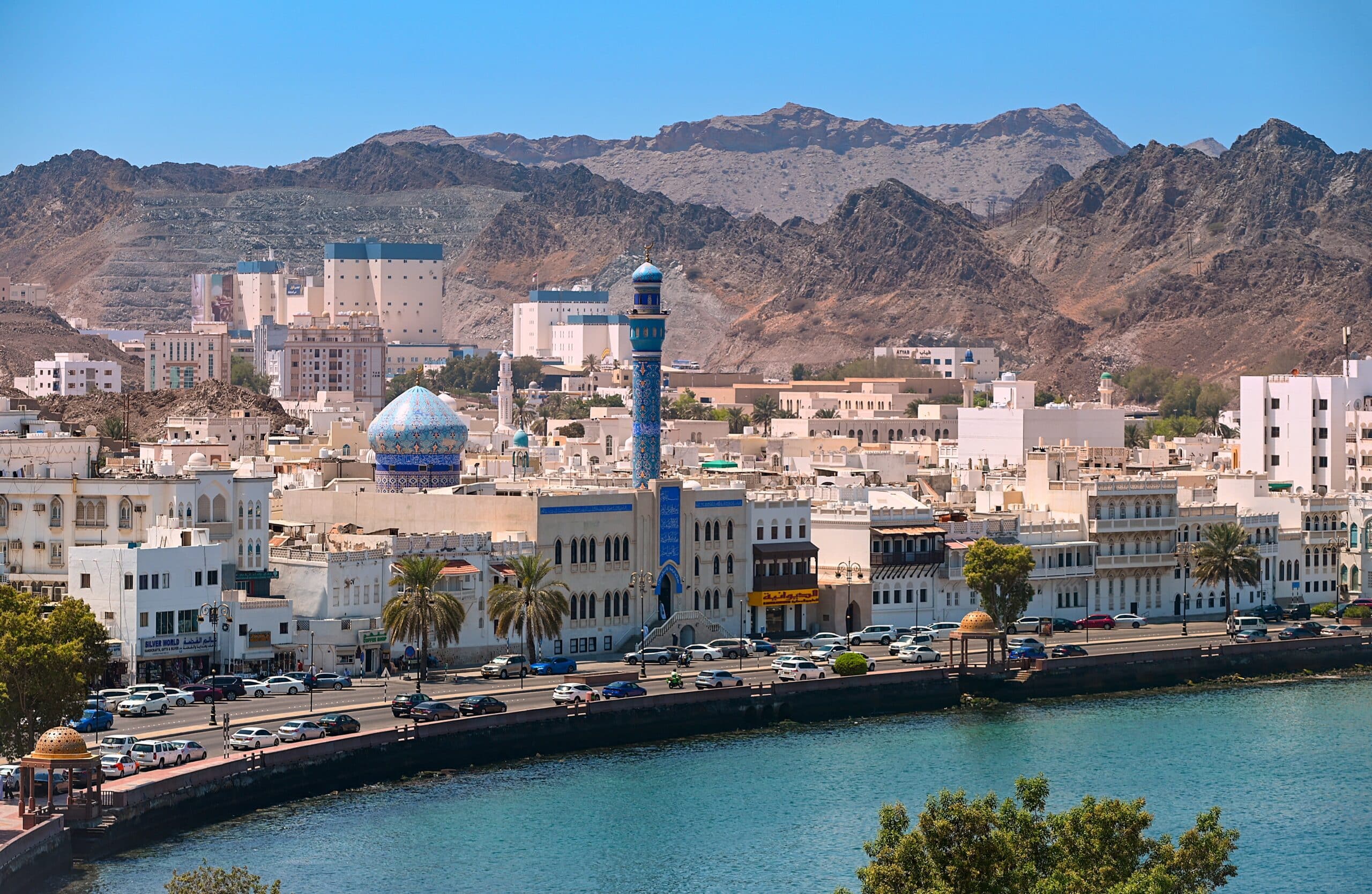 Panoramic view of Muscat Muttrah district with waterfront, traditional architecture in Oman during sunny day