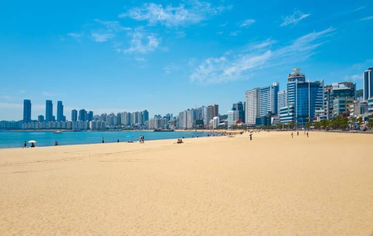 Wide sandy Gwangalli Beach with Busan skyline in the background