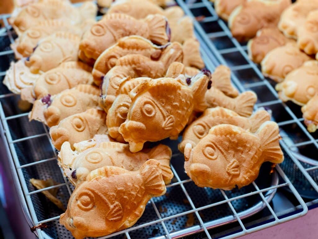 Bungeoppang Korean fish shaped pastry filled with sweet red bean paste on a street market grill