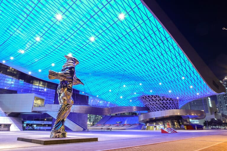 Busan Cinema Center illuminated at night with modern architecture