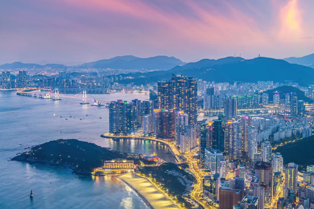 Night view of Gwangan Bridge glowing over Busan city lights